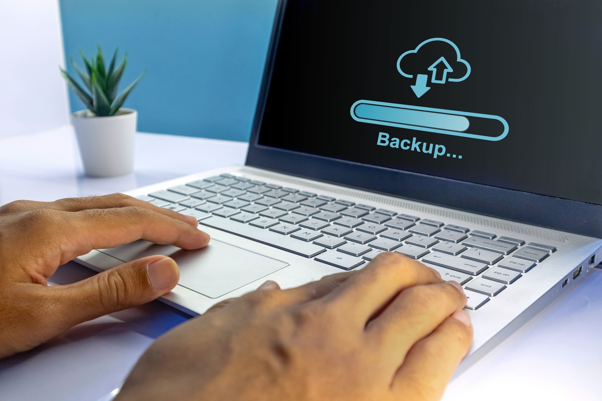 Man using a laptop to backup storage. Backup storage and cloud computing technology concept.